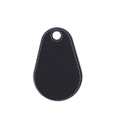 Black leather key tag with white stitching on a white background